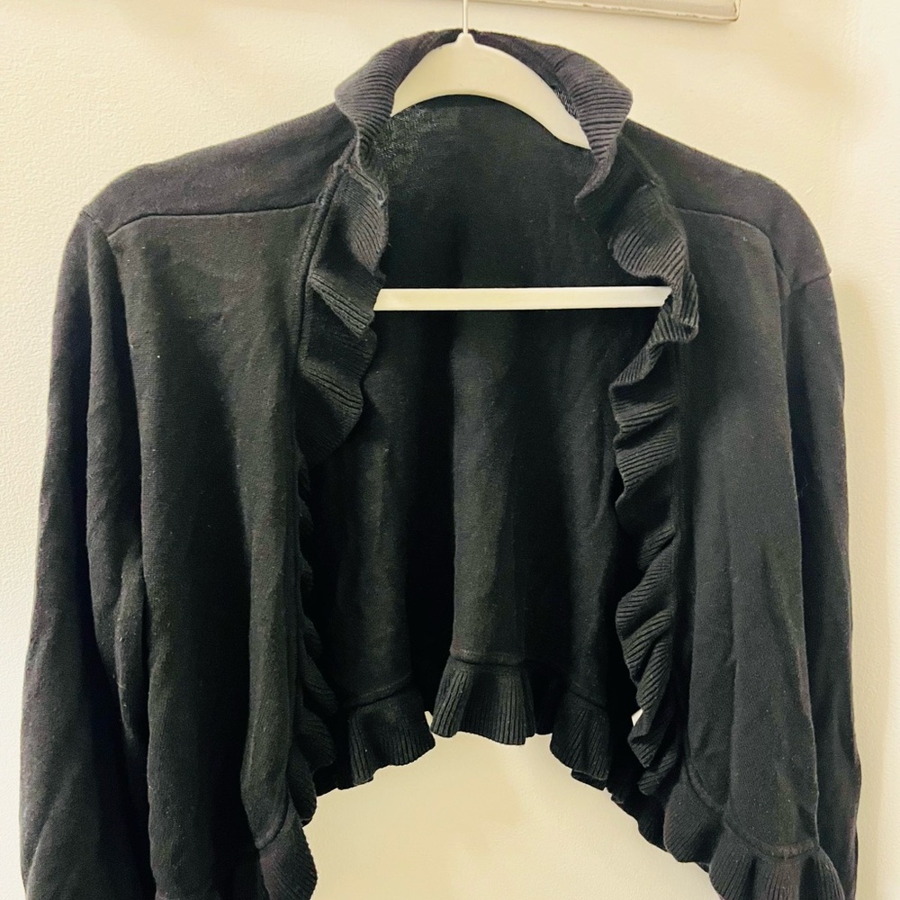 Cute, ruffle-edged, sweater shrug.